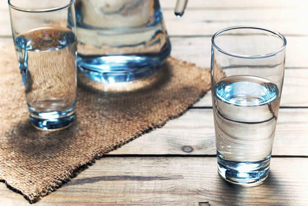 Glasses of water on a wooden table