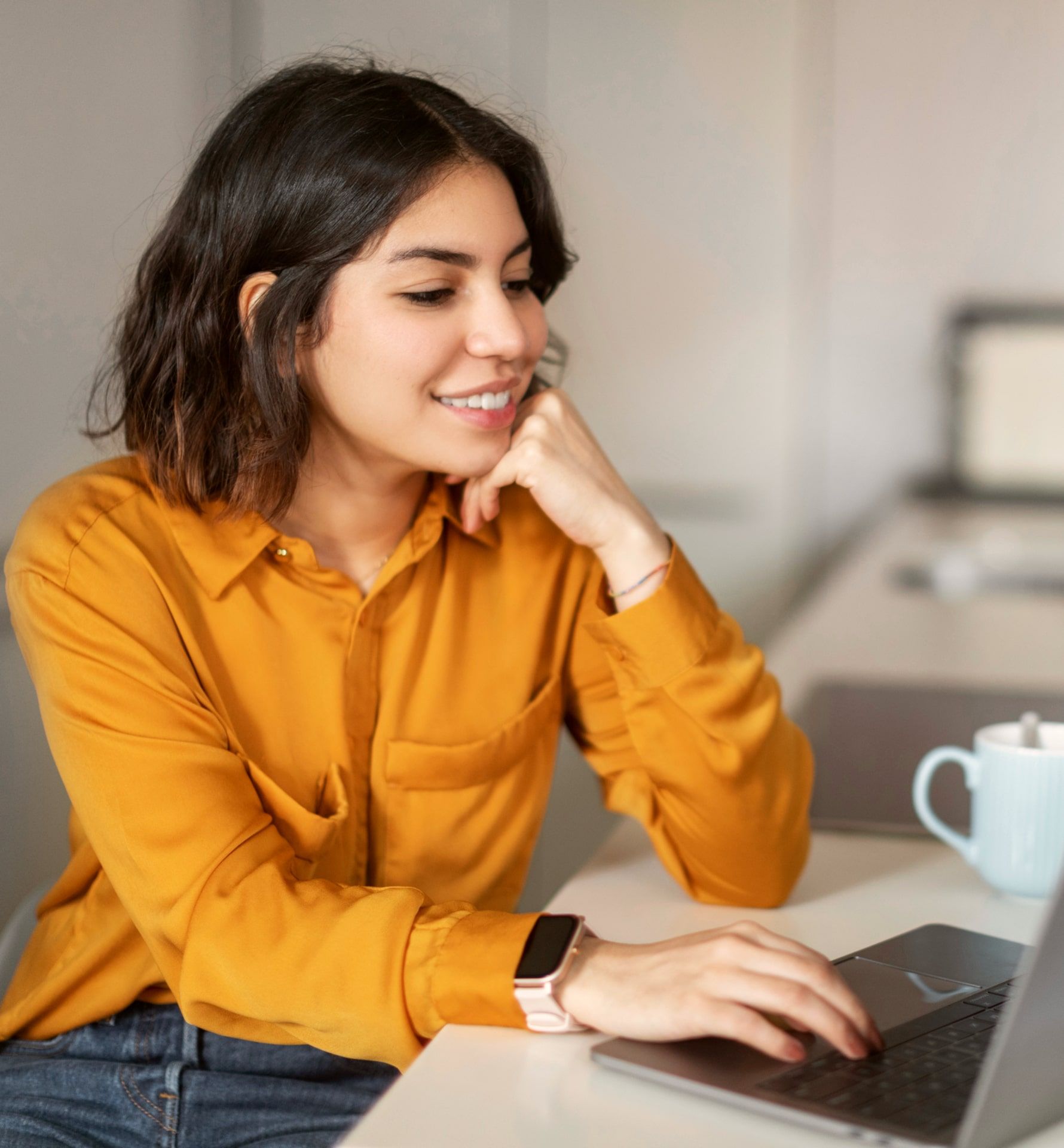 Smiling Young Arab Woman Working With Laptop In Kitchen