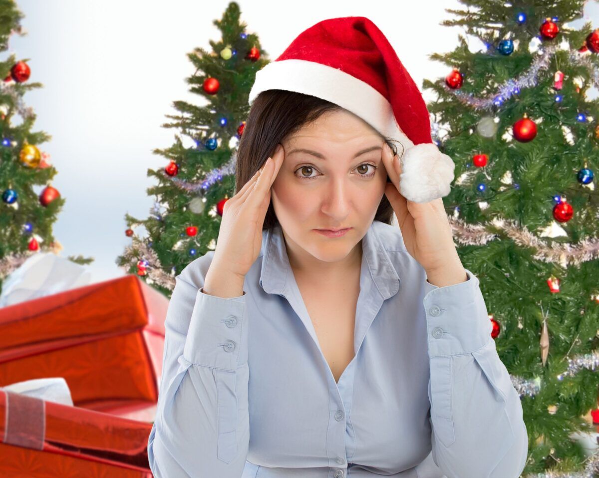 Stressed looking woman in a Santa hat