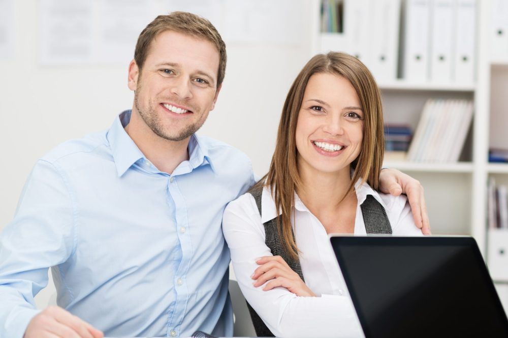 Smiling couple in a meeting with an adviser