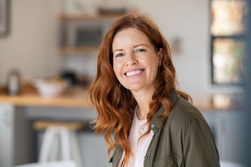 redhead woman in green shirt