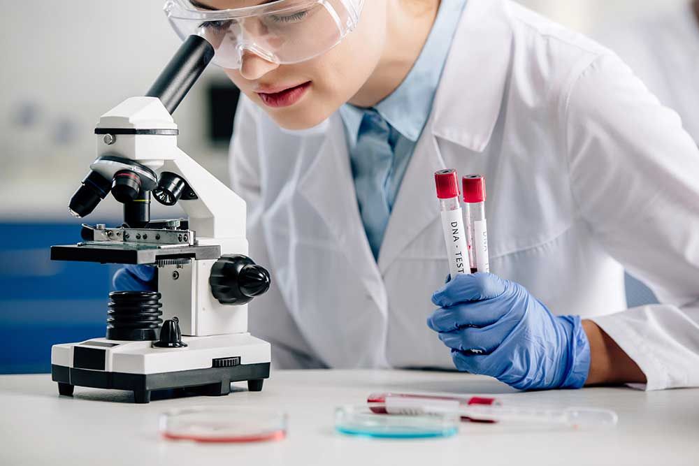 Cropped view of genetic consultant using microscope