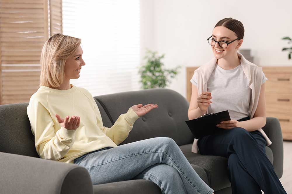 Professional psychotherapist working with on sofa