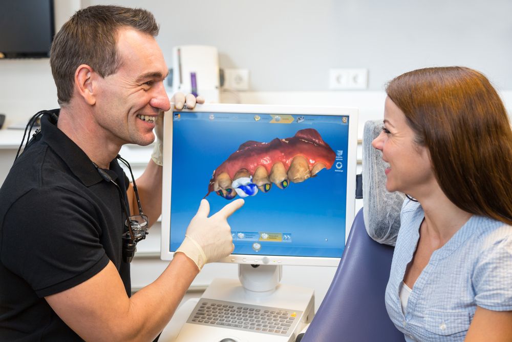 Dentist counseling patient about dental technology