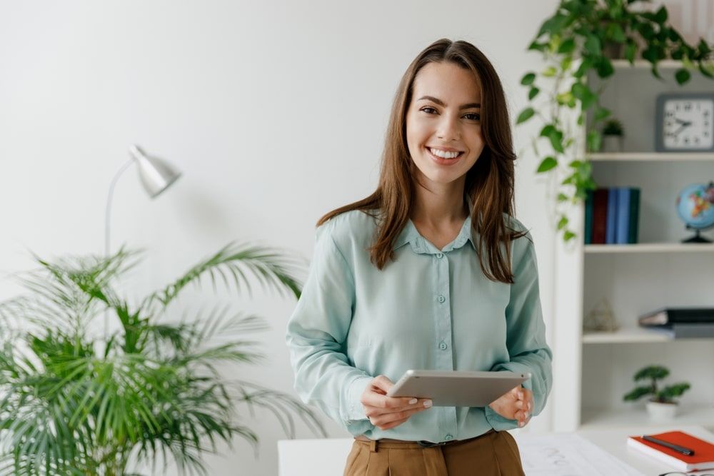 Smiling young woman stand at workplace