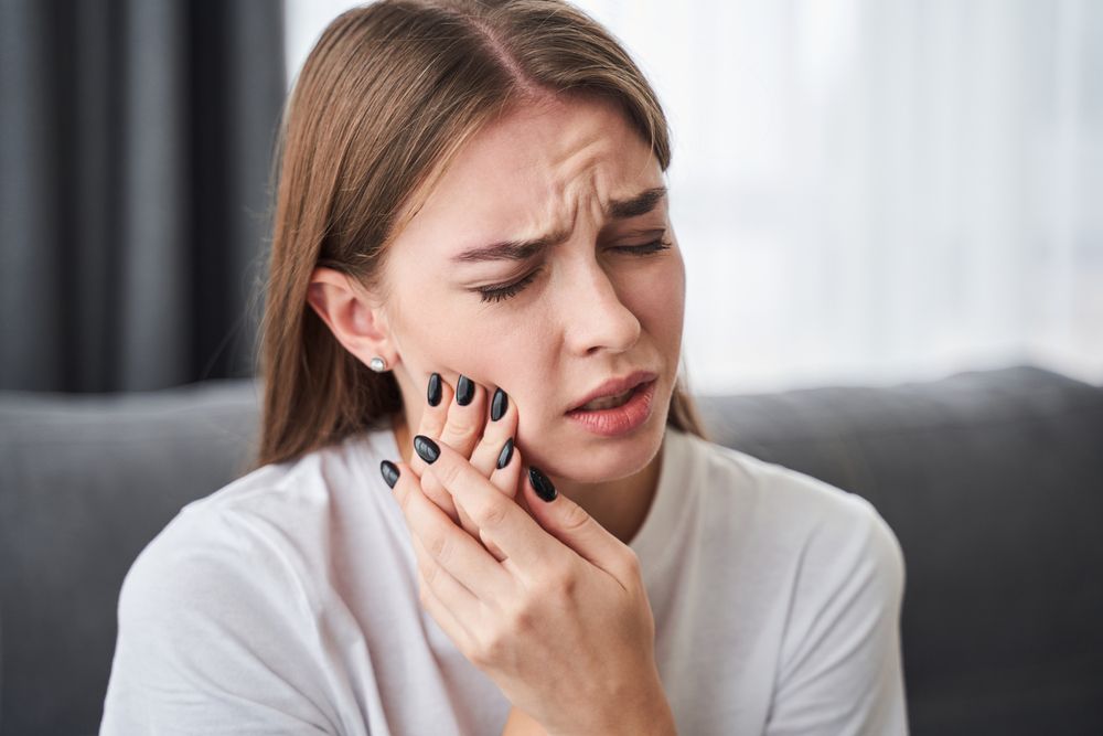 Frustrated young women suffering from toothache