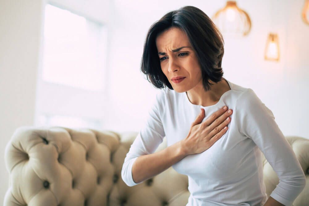woman who is suffering from a chest pain