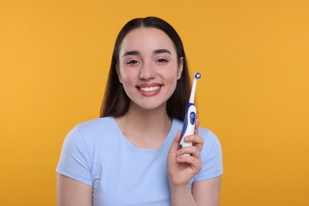 Girl holding a toothbrush