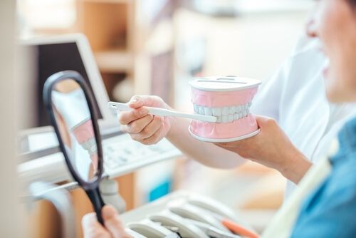 Dental hygienist teaching tooth brushing