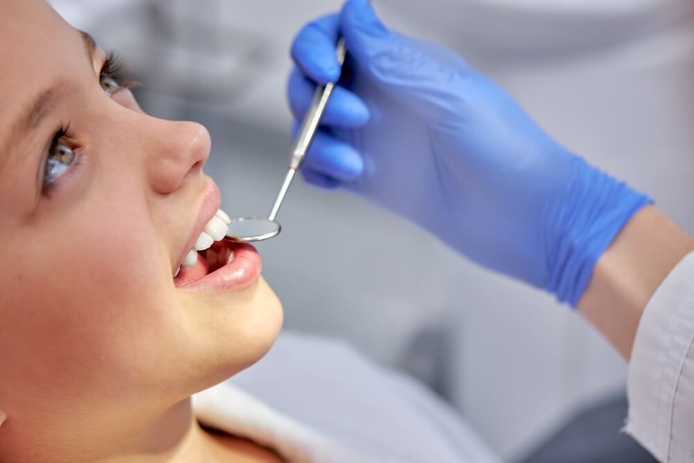 child girl is examined by dentist in dental clinic