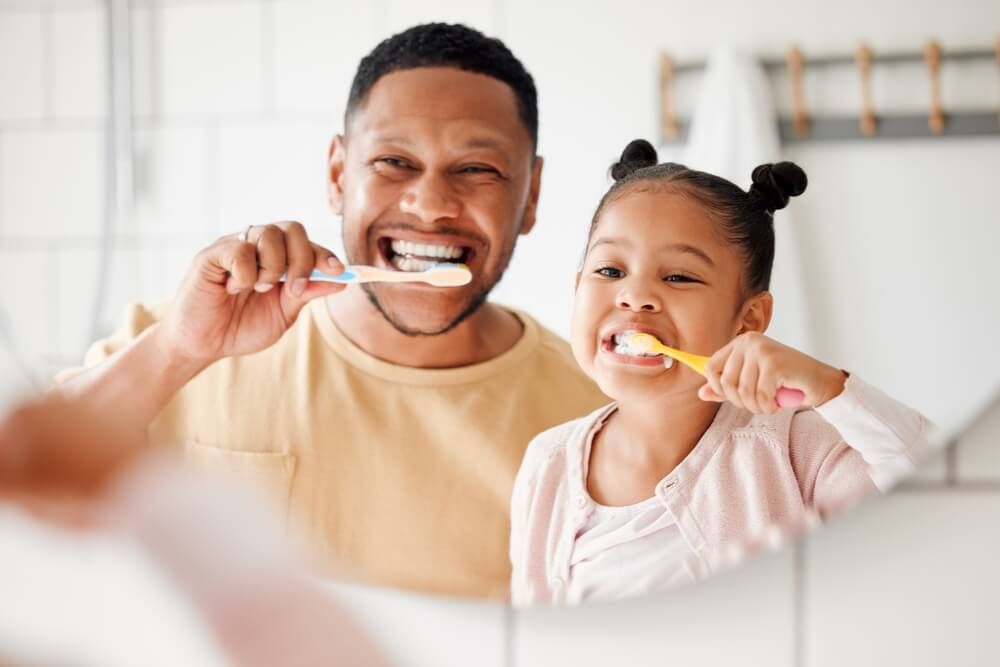 brushing teeth in a family home bathroom