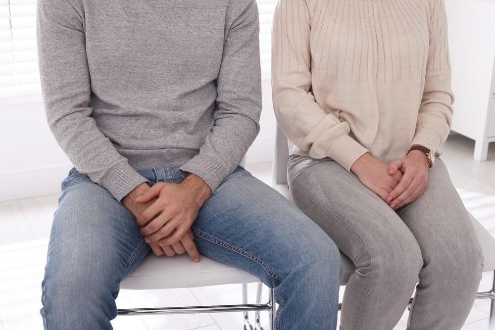 Couple waiting for appointment with STD specialist