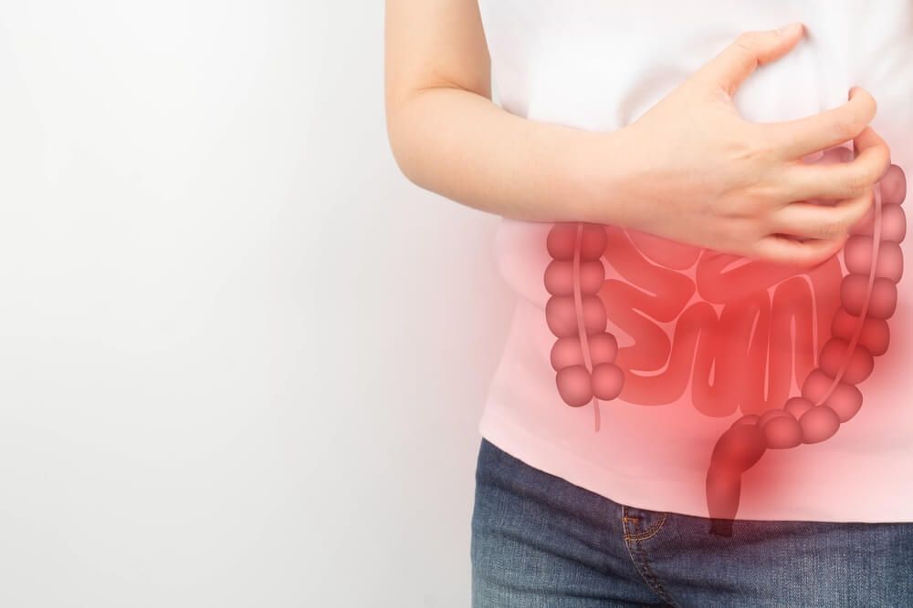 Woman suffering from abdominal pain with small and large intestines organ shape