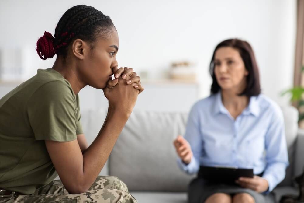 Upset Military Lady Having Therapy Session With Psychologist