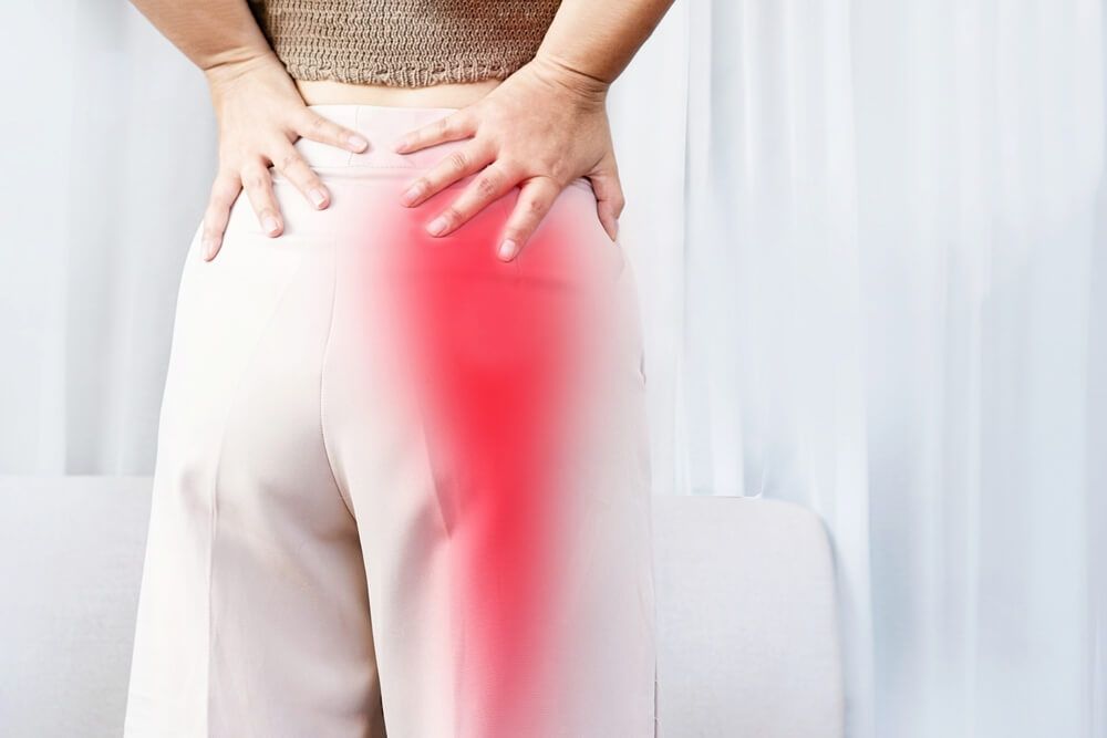 Sciatica Pain concept with woman suffering from buttock pain