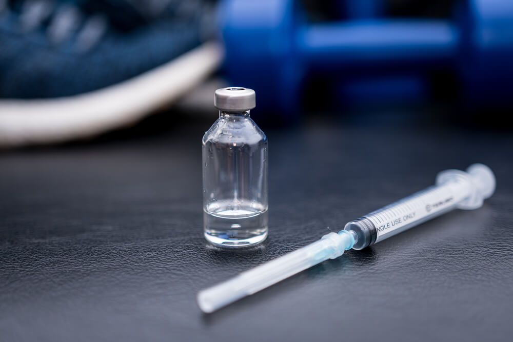 Bottle of doping drug and syringe