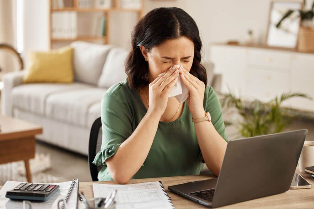 sick woman in home office with flu
