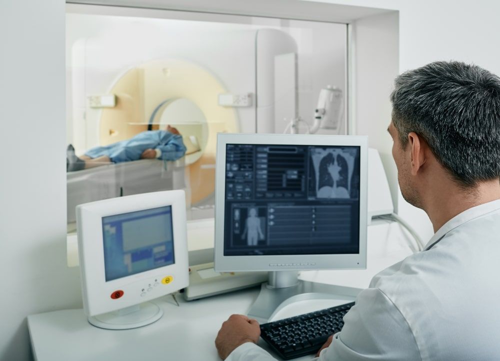 Doctor radiologist running CT scan for patient's body