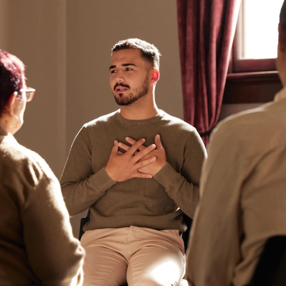 man sharing in group therapy with understanding