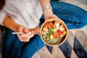 Woman with a bowl full of vegetables