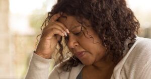 Stressed woman with curly hairs