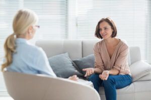 Woman,Talking,To,Therapist,On,Sofa,At,Home