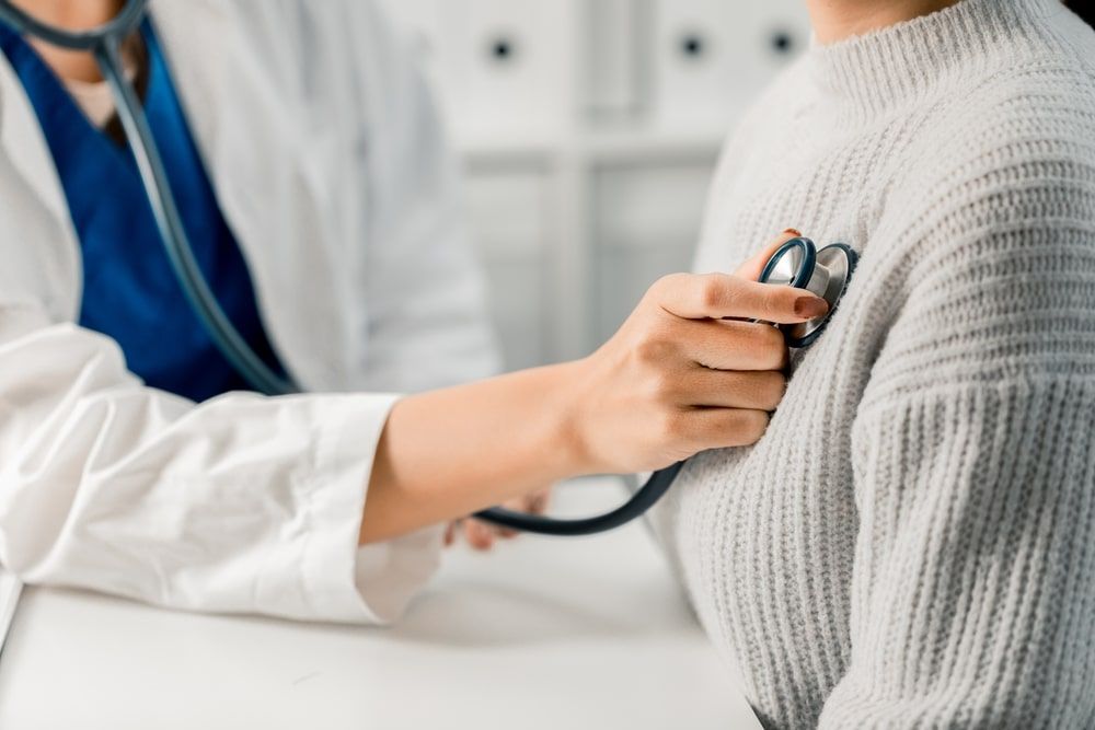 Female Doctor using stethoscope putting beat heart diagnose