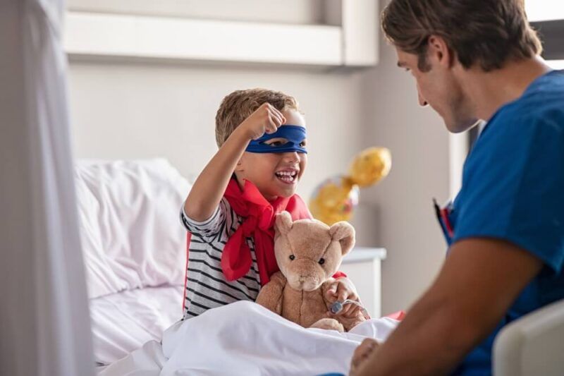 Strong little boy wearing superhero blue mask