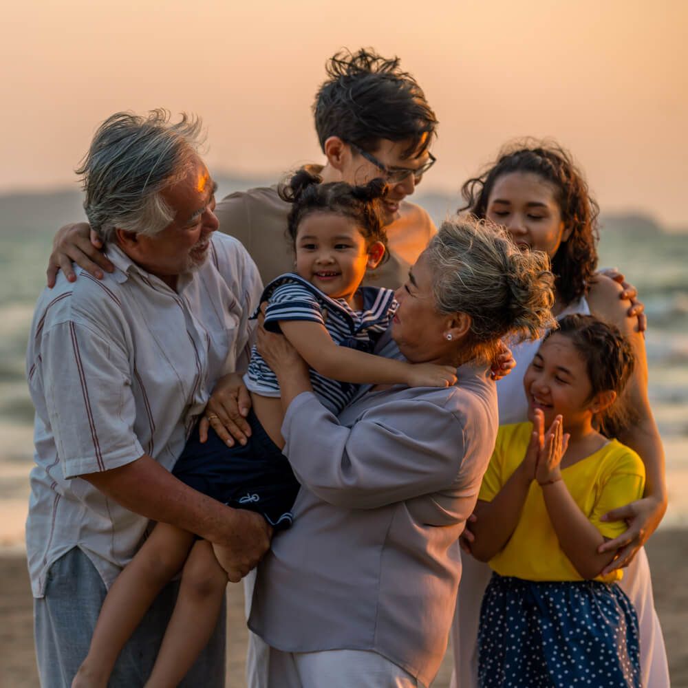 Happy big Asian family on beach holiday vacation