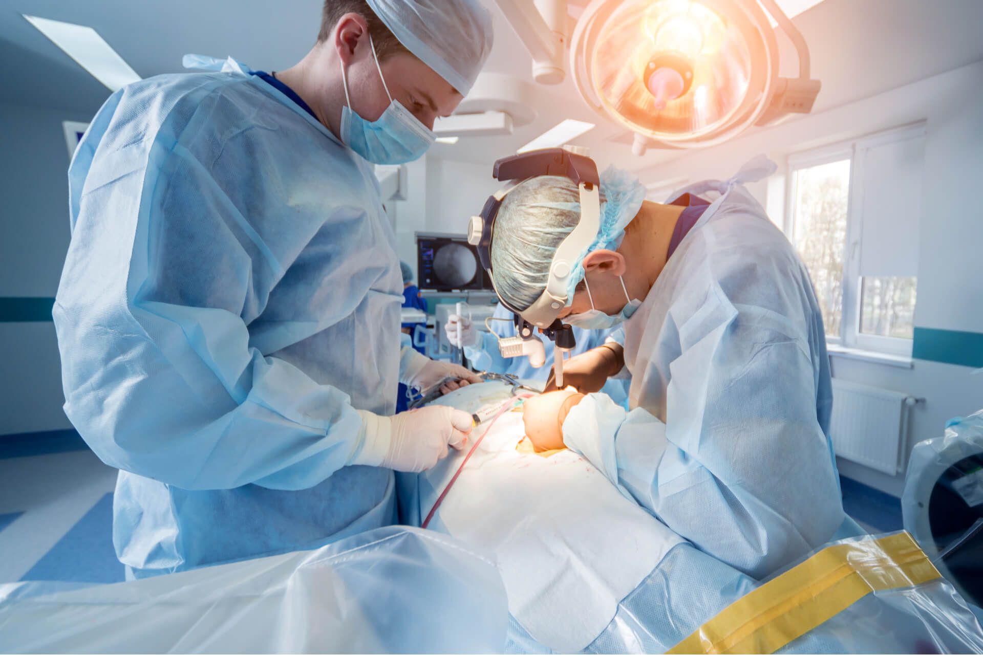 Group of surgeons in operating room with surgery equipment