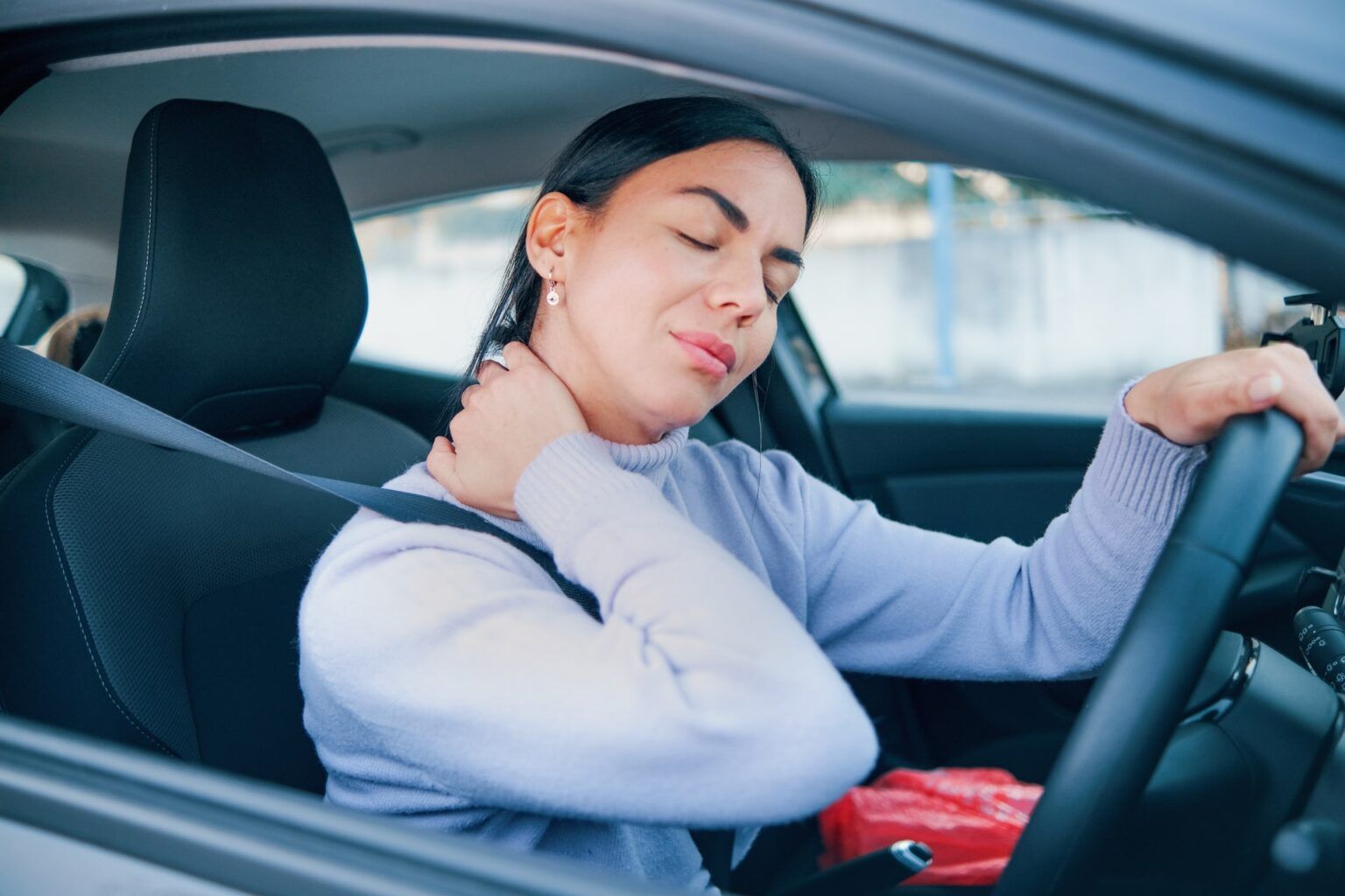 Women in vehicle having neck pain