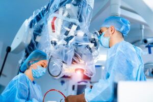 Team of surgeons operating in the hospital. Modern equipment in operating room. Medical devices for neurosurgery.