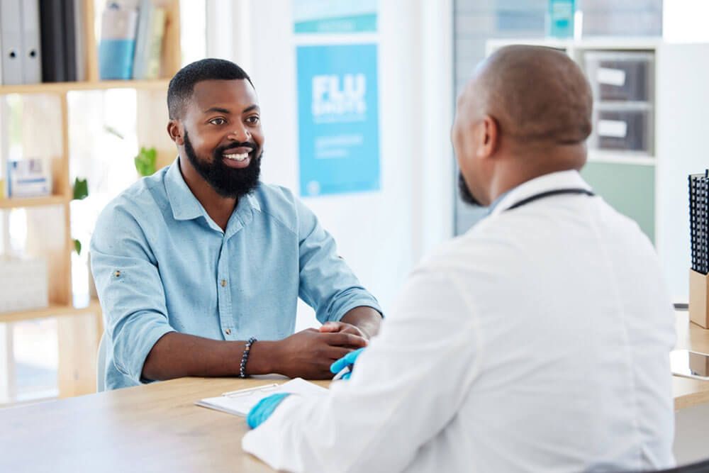 Happy man and doctor consultation