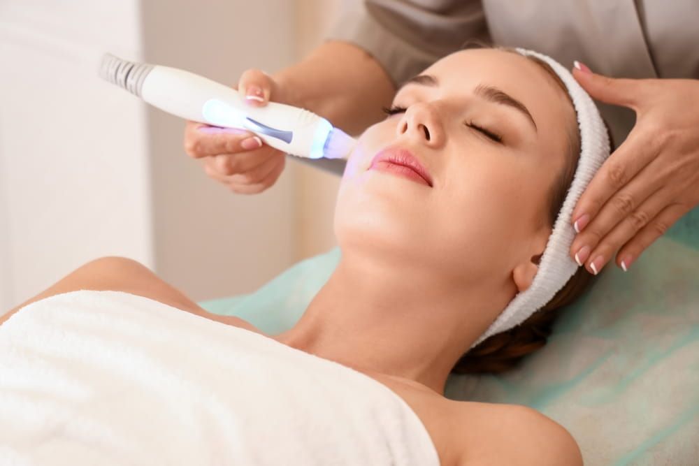 Pretty young woman visiting cosmetologist in beauty salon