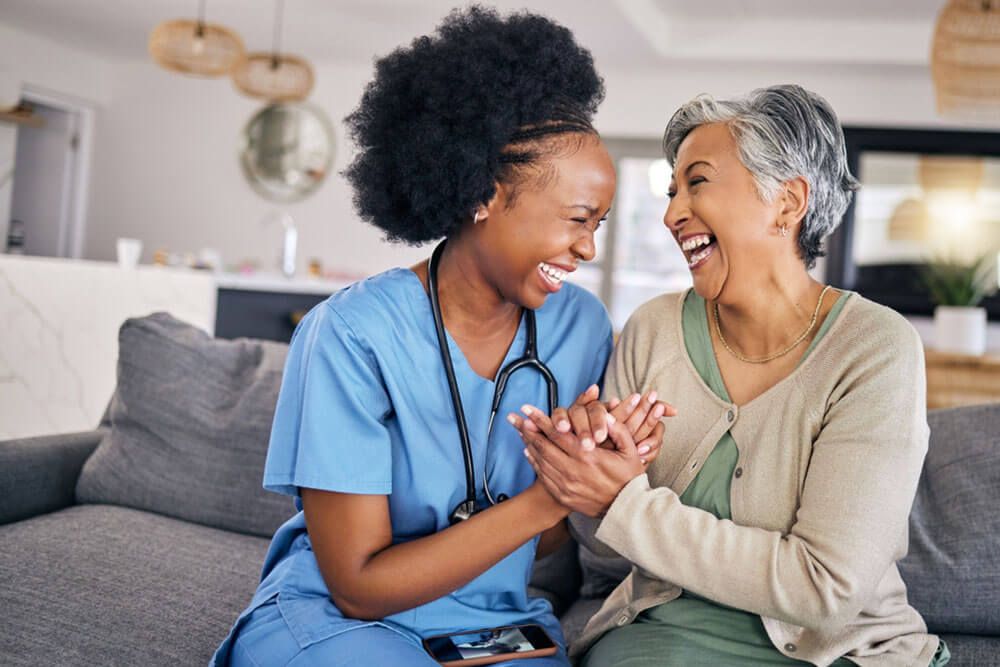 Smile, funny and assisted living caregiver with an old woman in her home during retirement together.