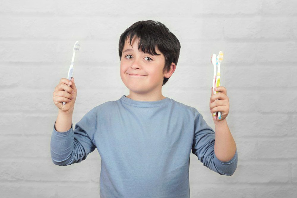 Kid with tooth brushes