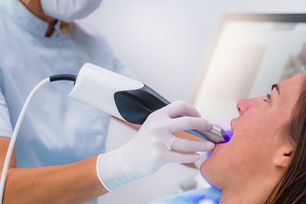 Dentist Using 3D Dental Camera for Scanning Teeth.