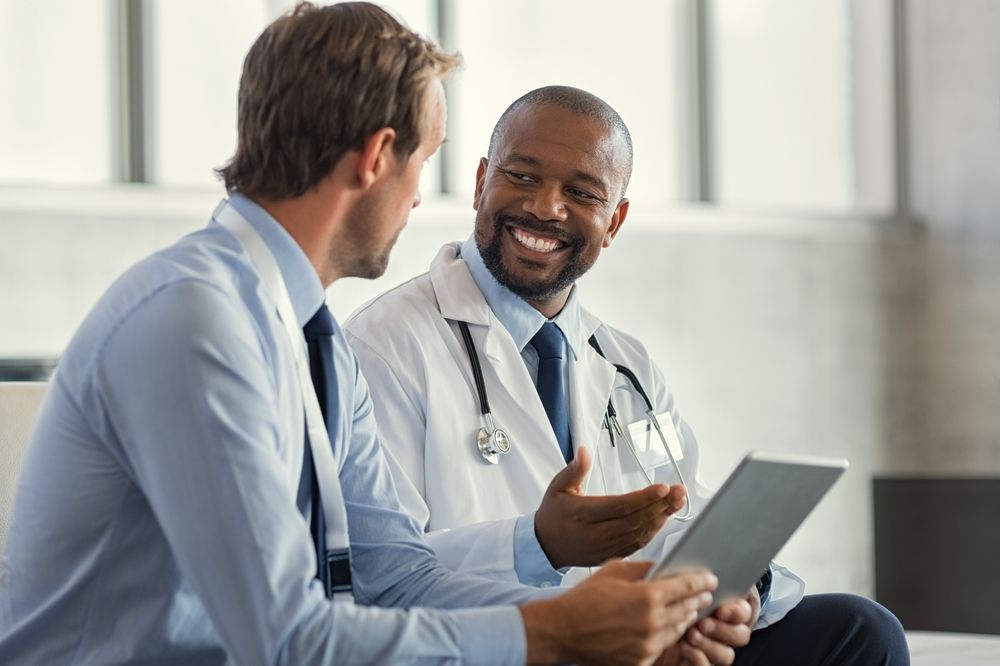 Two Mature Smiling Doctors Having Discussion