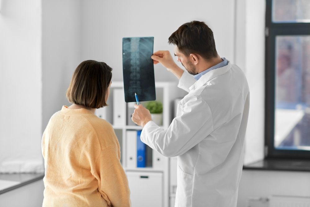 Male Doctor Showing X-ray