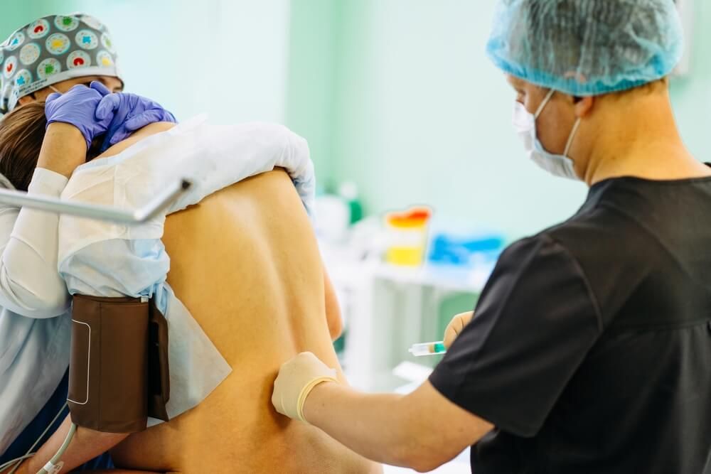 Male doctor injecting Epidural Anesthesia