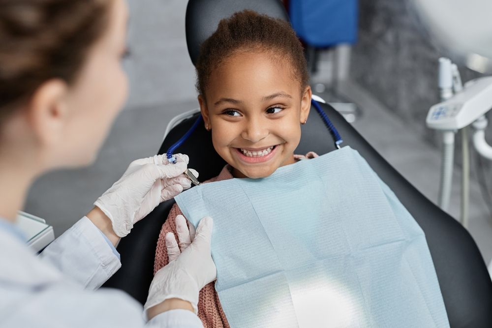 Portrait,Of,Smiling,Little,Girl,In,Dental,Chair,With,Nurse