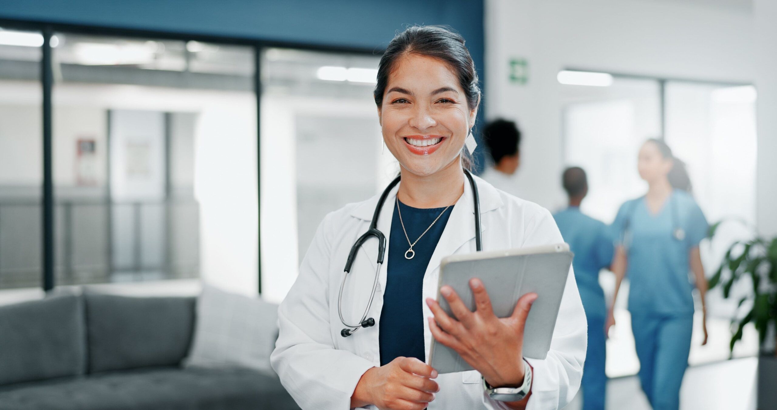 Happy woman or doctor in busy hospital