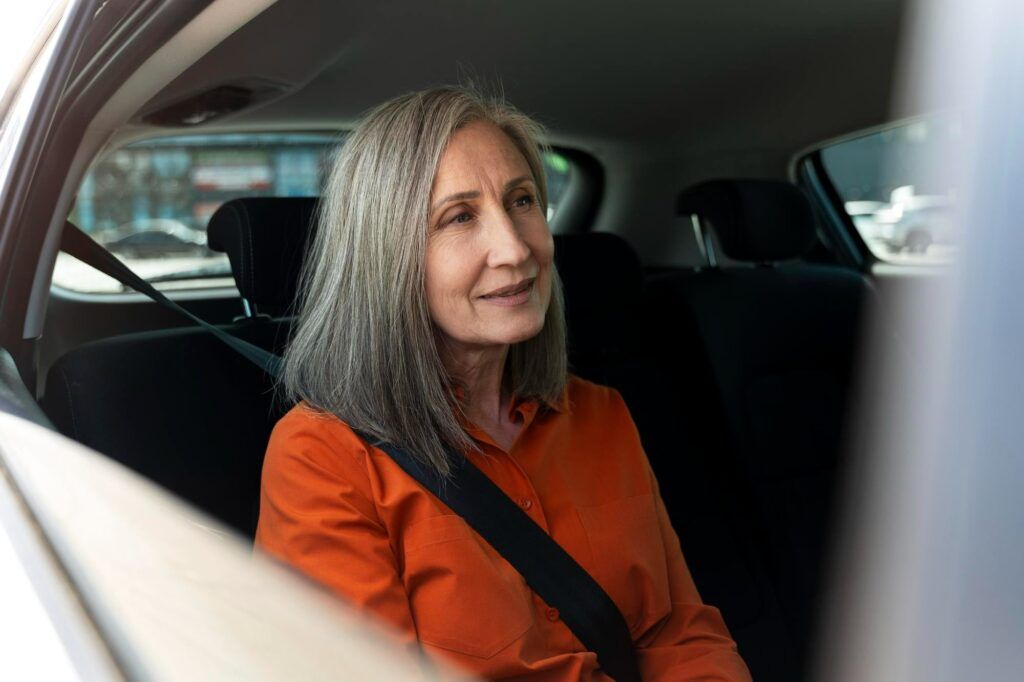 Aged woman sitting in car