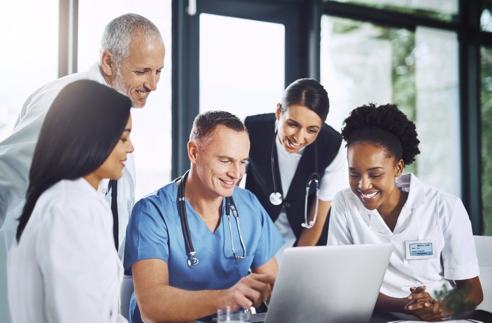 Healthcare meeting and doctors with laptop for research