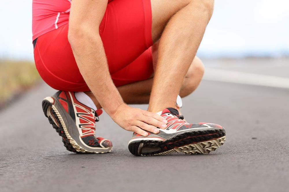 Broken twisted ankle of male runner