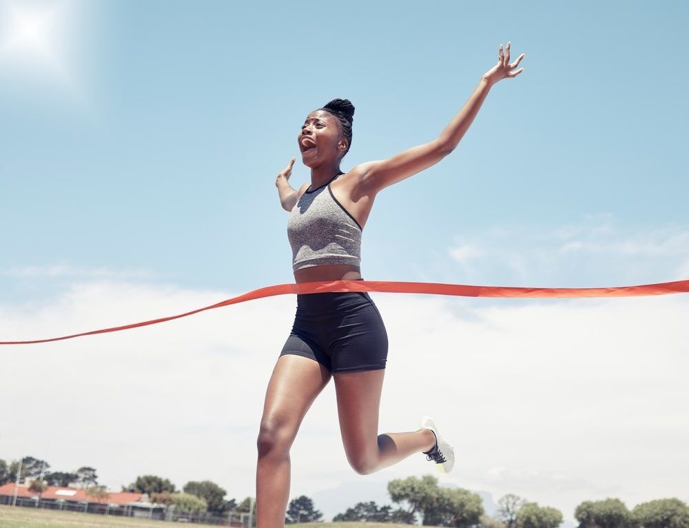 woman at finish line for victory