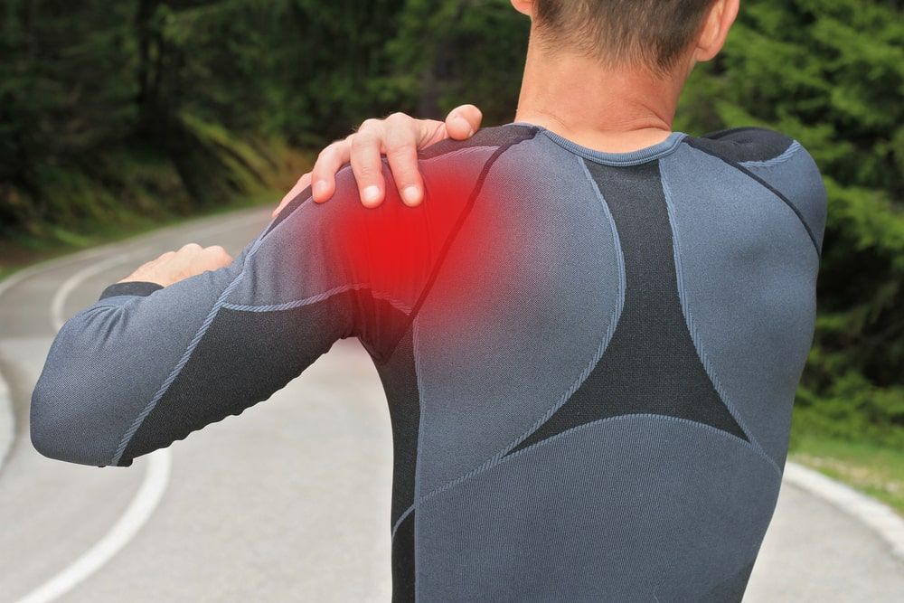 man suffering from back pain and injury on the shoulder