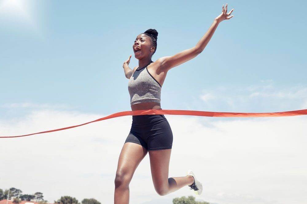 woman at finish line for victory