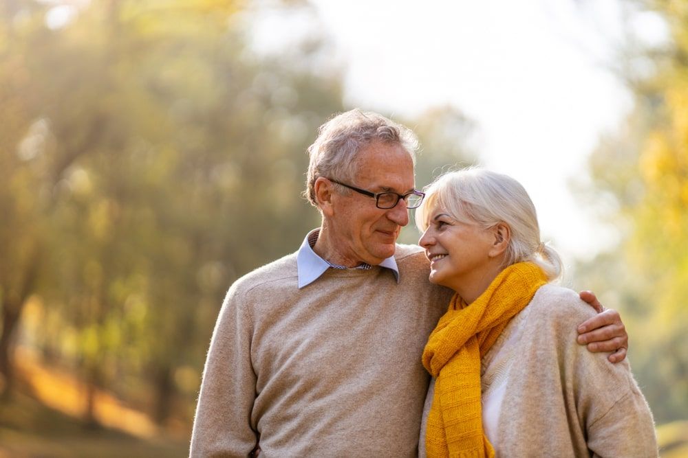 Happy senior couple in autumn park