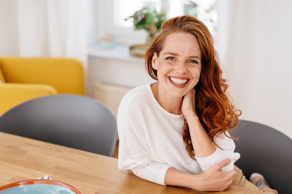 friendly young redhead woman with lovely wide warm smile